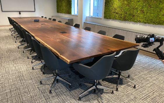 An Acre Made custom solid wood boardroom table in an office space