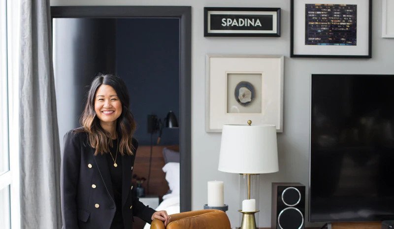 Natalie Chong, an interior designer, standing in a room smiling