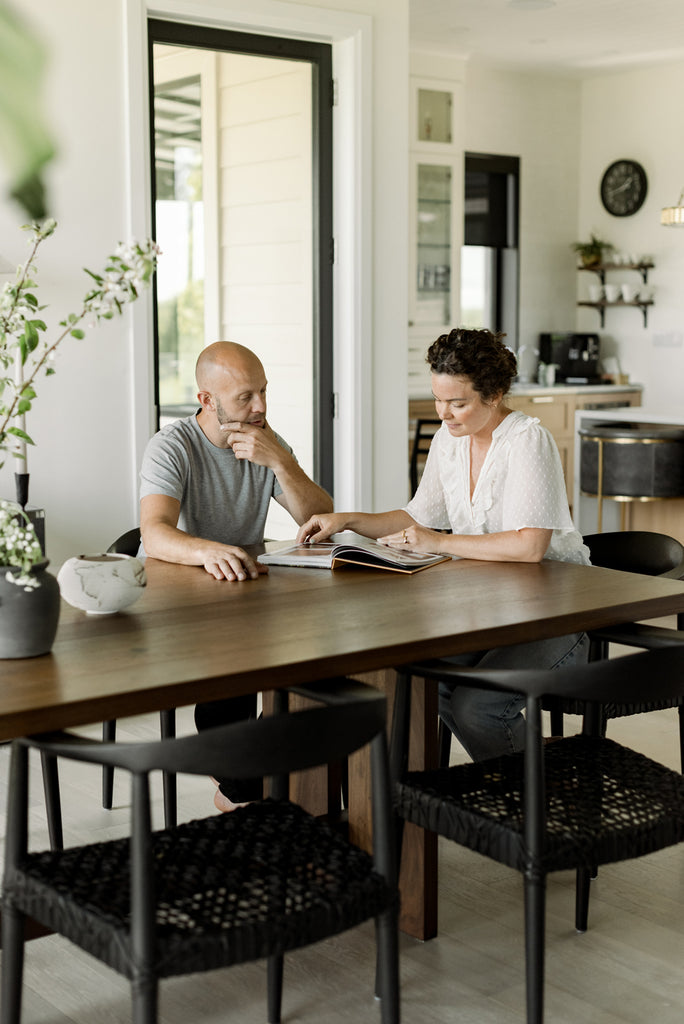 Jack Fouracre and Danielle Corriveau, owners of Acre Made, sit at solid wood walnut dining table